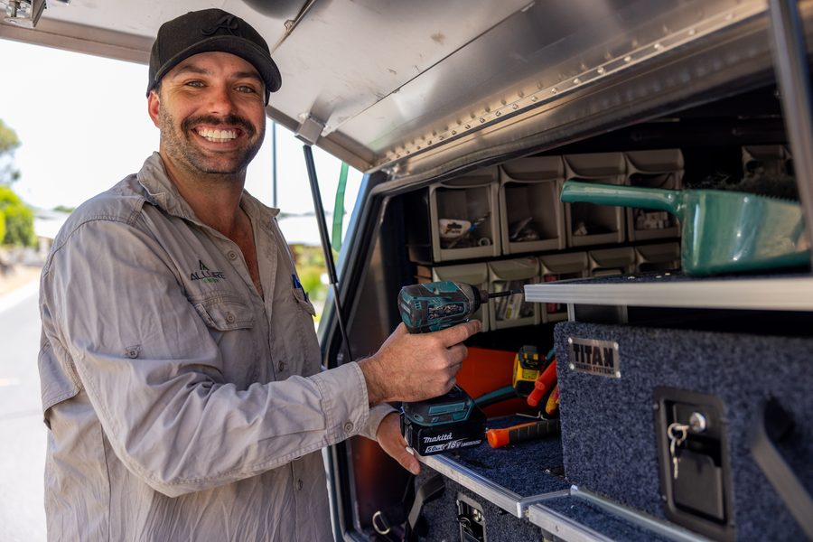 Allure electrician grabbing tools from the service vehicle