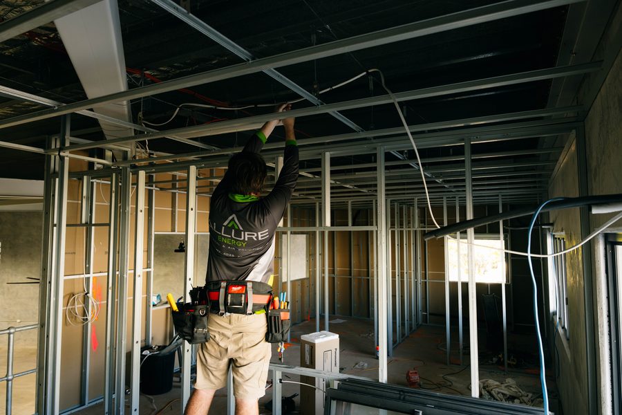 Electrician carrying a ladder to the job